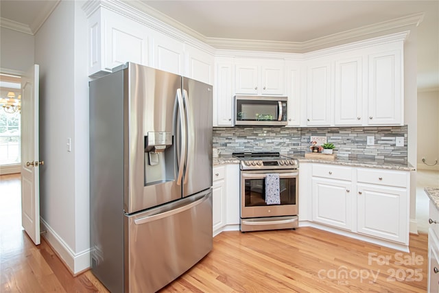 2019 Heirloom Ct, Matthews, NC 28104 - kitchen with appliances with stainless steel finishes, ornamental molding, light wood-style flooring, decorative backsplash, and white cabinets