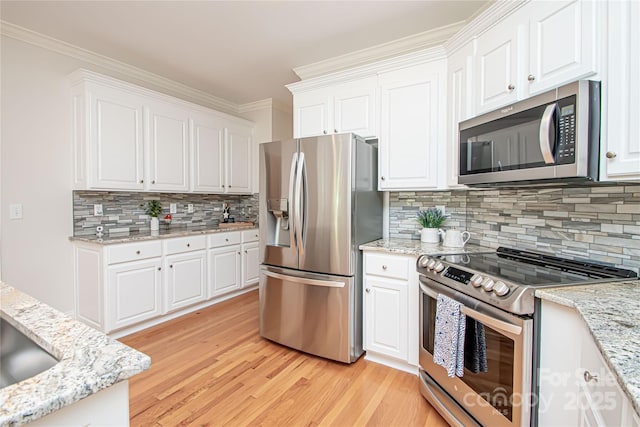 2019 Heirloom Ct, Matthews, NC 28104 - kitchen featuring appliances with stainless steel finishes, light wood-style floors, decorative backsplash, white cabinets, and crown molding
