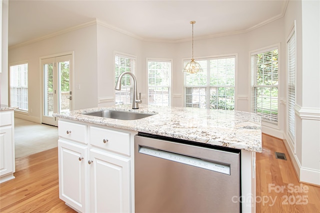 2019 Heirloom Ct, Matthews, NC 28104 - kitchen featuring stainless steel dishwasher, light wood-style floors, white cabinets, pendant lighting, and a center island with sink