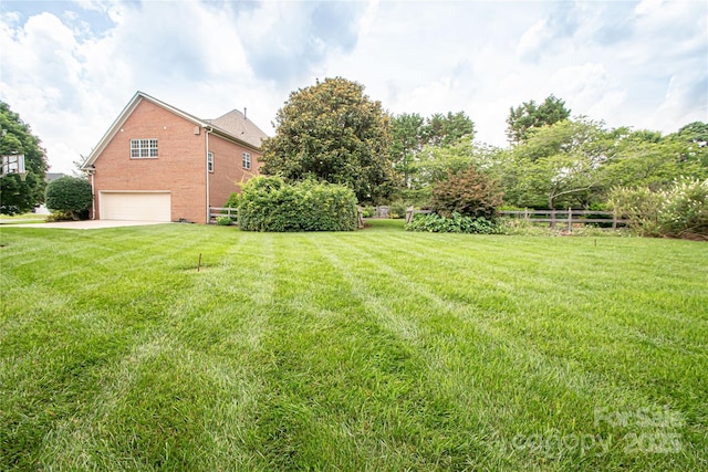 2019 Heirloom Ct, Matthews, NC 28104 - view of yard featuring a garage and concrete driveway