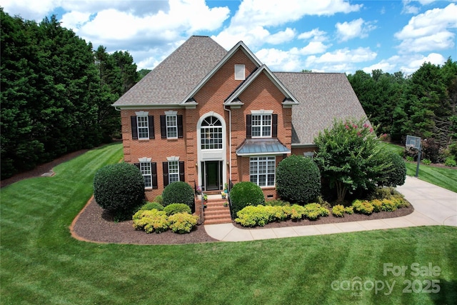 2019 Heirloom Ct, Matthews, NC 28104 - view of front of home with brick siding, a front lawn, and a shingled roof