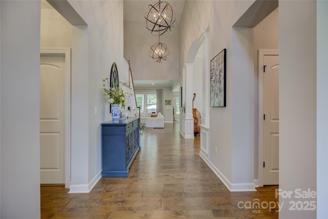 17537 Caddy Ct, Charlotte, NC 28278 - hallway with wood finished floors, a high ceiling, and a chandelier
