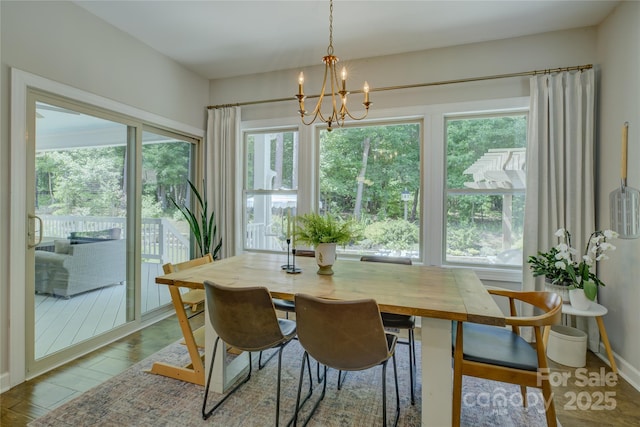 17537 Caddy Ct, Charlotte, NC 28278 - dining area featuring healthy amount of natural light, a chandelier, and wood finished floors
