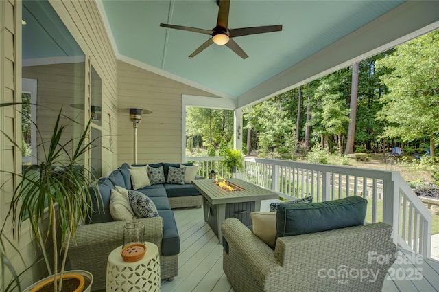 17537 Caddy Ct, Charlotte, NC 28278 - wooden deck featuring an outdoor living space with a fire pit, a ceiling fan, and view of wooded area