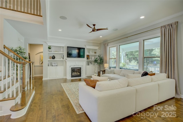 17537 Caddy Ct, Charlotte, NC 28278 - living room featuring a ceiling fan, ornamental molding, a high end fireplace, stairs, and wood finished floors