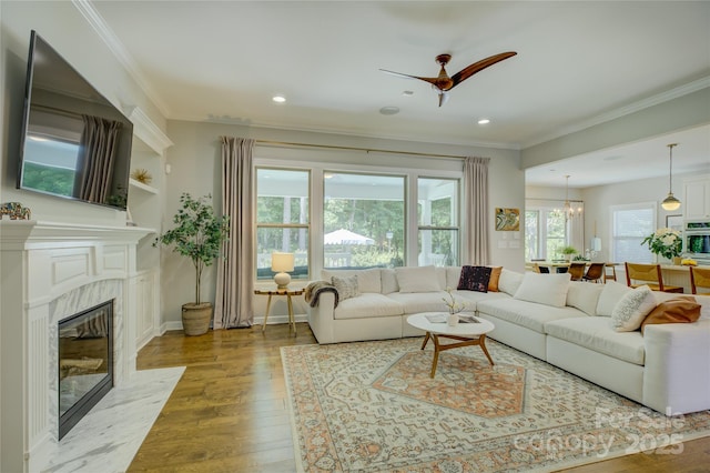 17537 Caddy Ct, Charlotte, NC 28278 - living room with a fireplace, wood finished floors, a ceiling fan, ornamental molding, and recessed lighting