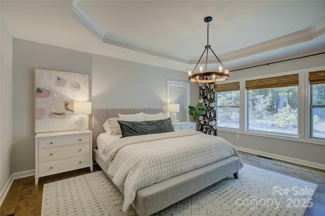 17537 Caddy Ct, Charlotte, NC 28278 - bedroom with ornamental molding, a tray ceiling, a chandelier, and dark wood-type flooring