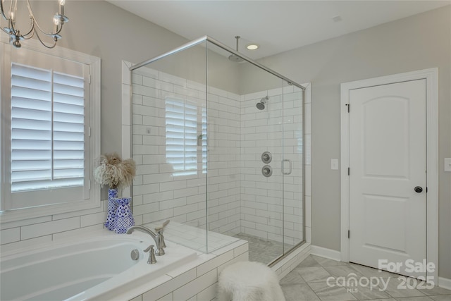17537 Caddy Ct, Charlotte, NC 28278 - full bathroom featuring a shower stall, a garden tub, plenty of natural light, and a chandelier