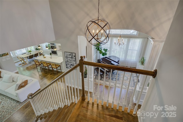 17537 Caddy Ct, Charlotte, NC 28278 - stairs featuring a chandelier, plenty of natural light, and wood-type flooring