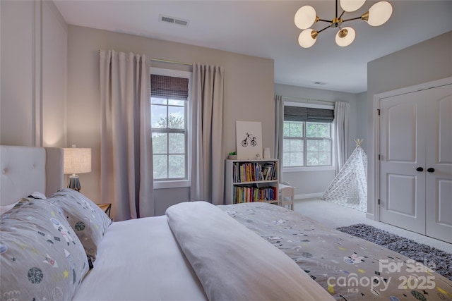 17537 Caddy Ct, Charlotte, NC 28278 - carpeted bedroom featuring a chandelier and a closet
