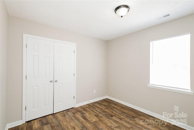 201 Killian Cir, Clover, SC 29710 - unfurnished bedroom featuring a closet, dark wood-style floors, and a textured ceiling