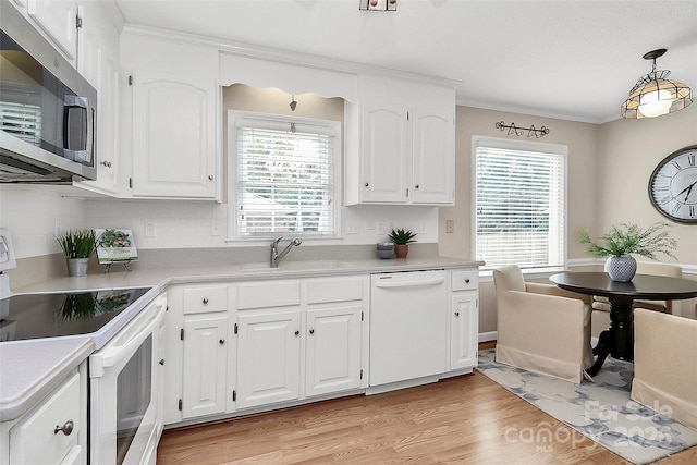 3304 Chilham Pl, Charlotte, NC 28226 - kitchen with white appliances, light wood-style flooring, light countertops, and crown molding
