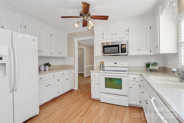 3304 Chilham Pl, Charlotte, NC 28226 - kitchen featuring white appliances, white cabinetry, light wood-style floors, and crown molding
