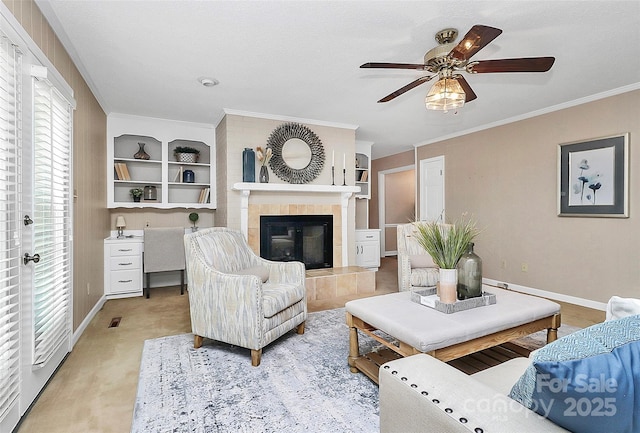 3304 Chilham Pl, Charlotte, NC 28226 - living room with a ceiling fan, a fireplace, built in shelves, and crown molding