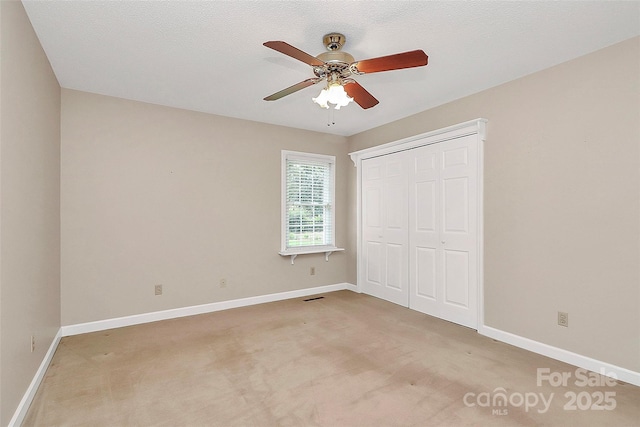 3304 Chilham Pl, Charlotte, NC 28226 - unfurnished bedroom with light carpet, a closet, and a ceiling fan