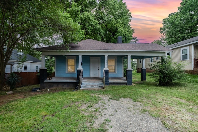 4510 Wildwood Ave, Charlotte, NC 28208 - bungalow-style house with covered porch, a chimney, and roof with shingles