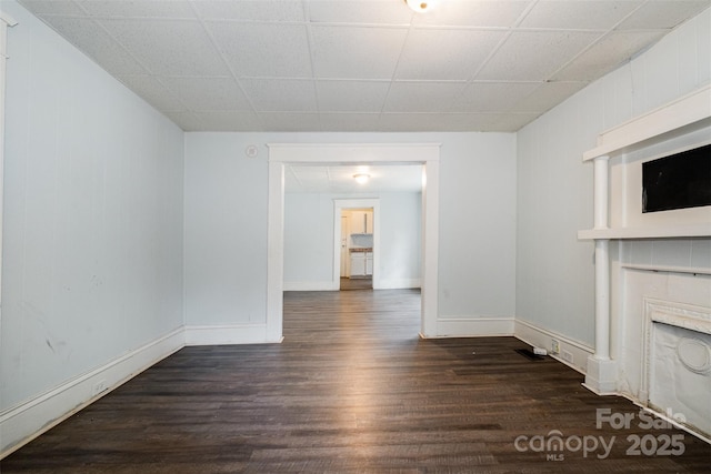 4510 Wildwood Ave, Charlotte, NC 28208 - unfurnished living room with wood finished floors and a tiled fireplace