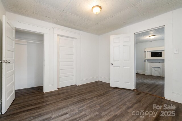 4510 Wildwood Ave, Charlotte, NC 28208 - unfurnished bedroom featuring dark wood-type flooring and a closet
