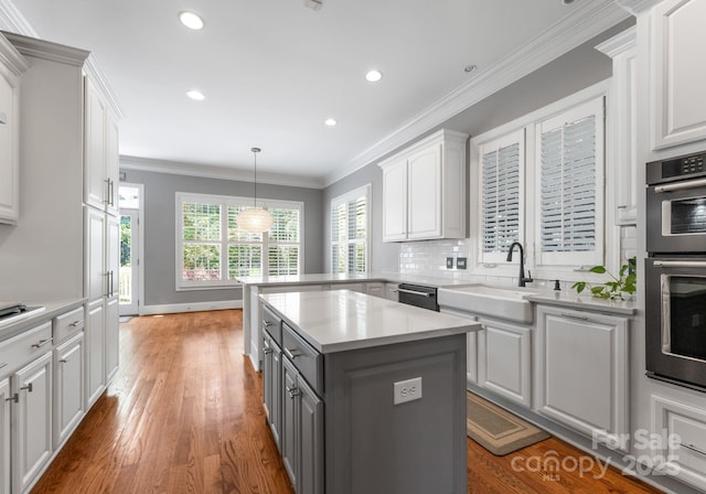 4536 Rustling Woods Dr, Denver, NC 28037 - kitchen featuring gray cabinetry, white cabinetry, appliances with stainless steel finishes, light countertops, and ornamental molding