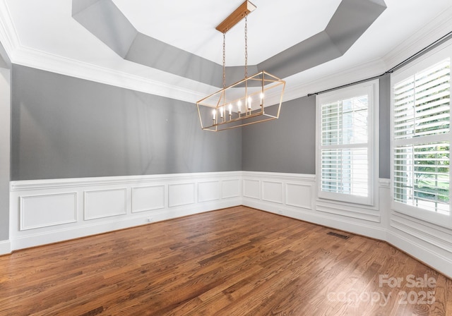 4536 Rustling Woods Dr, Denver, NC 28037 - unfurnished room with crown molding, a tray ceiling, healthy amount of natural light, a chandelier, and wood finished floors