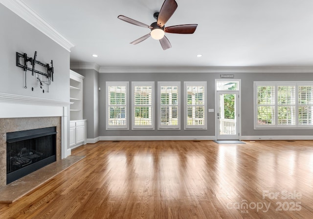 4536 Rustling Woods Dr, Denver, NC 28037 - unfurnished living room with a fireplace, plenty of natural light, wood finished floors, ornamental molding, and recessed lighting