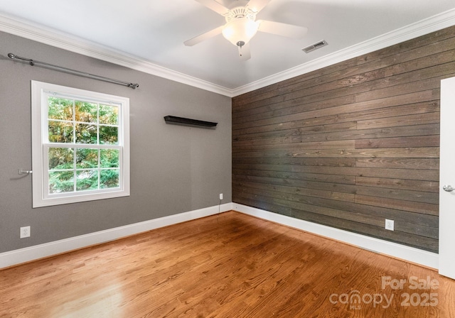 4536 Rustling Woods Dr, Denver, NC 28037 - empty room featuring ornamental molding, wood finished floors, wood walls, and a ceiling fan