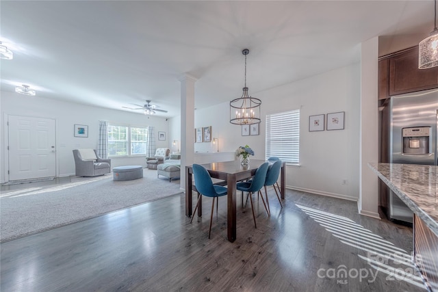 4113 Bent Green Ln, Monroe, NC 28112 - dining space with dark wood finished floors, a chandelier, ceiling fan, and decorative columns