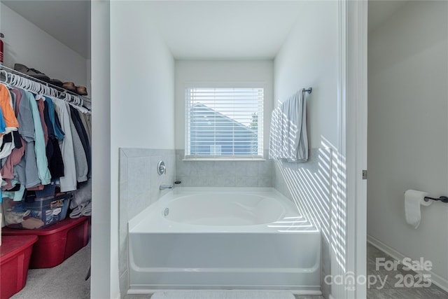 4113 Bent Green Ln, Monroe, NC 28112 - bathroom with a bath and a spacious closet