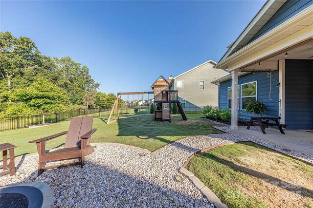 4113 Bent Green Ln, Monroe, NC 28112 - fenced backyard featuring a playground and a patio