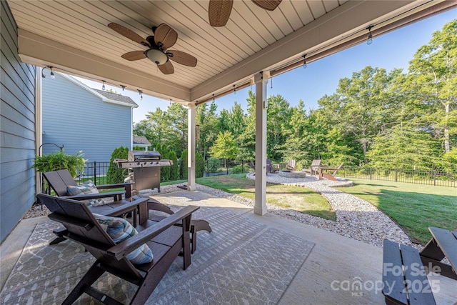 4113 Bent Green Ln, Monroe, NC 28112 - fenced backyard with a fire pit, ceiling fan, a patio, and view of scattered trees