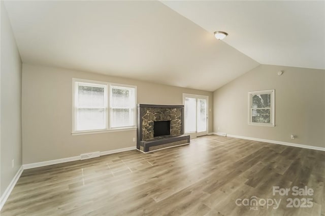 4937 Post Oak Ln, Rock Hill, SC 29732 - unfurnished living room featuring wood finished floors, a fireplace, and vaulted ceiling