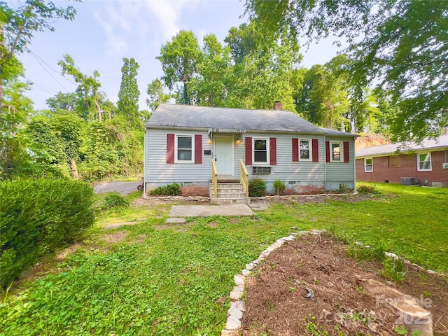 413 Forest Pl NW, Lenoir, NC 28645 - view of front of house featuring a front yard, crawl space, a chimney, and a shingled roof