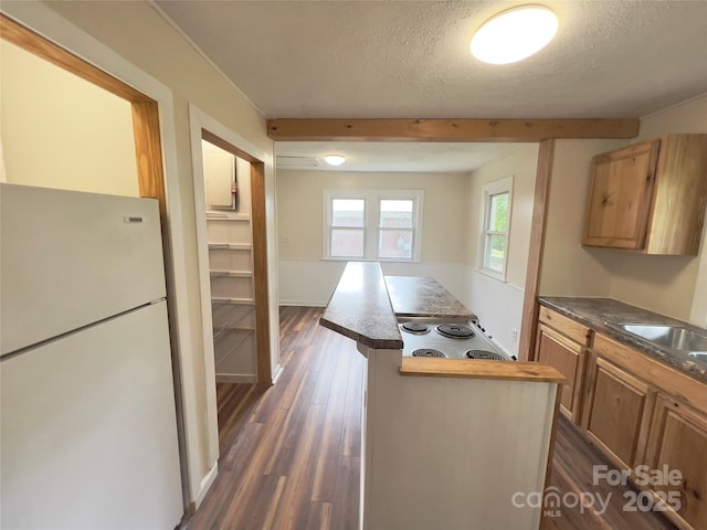 413 Forest Pl NW, Lenoir, NC 28645 - kitchen with freestanding refrigerator, a textured ceiling, dark wood finished floors, a kitchen island, and cooktop