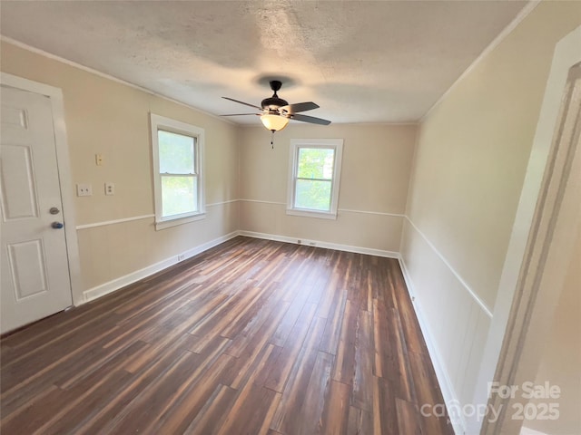 413 Forest Pl NW, Lenoir, NC 28645 - spare room featuring dark wood-style flooring, ornamental molding, a ceiling fan, and a textured ceiling