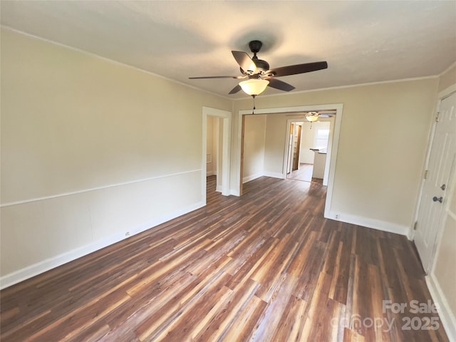 413 Forest Pl NW, Lenoir, NC 28645 - spare room featuring ceiling fan, dark wood finished floors, and ornamental molding