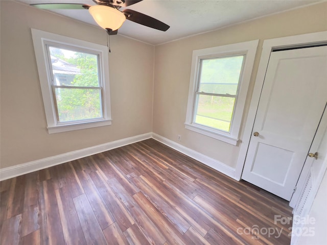 413 Forest Pl NW, Lenoir, NC 28645 - unfurnished room with healthy amount of natural light, dark wood-style floors, and ceiling fan