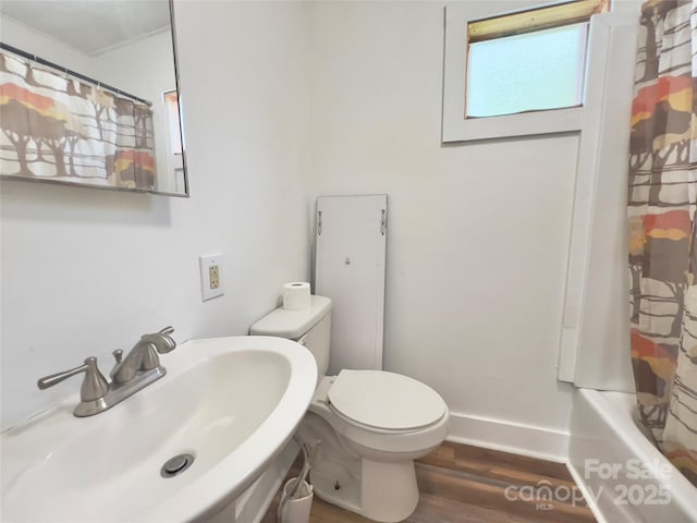 413 Forest Pl NW, Lenoir, NC 28645 - full bathroom featuring wood finished floors and shower / bath combination with curtain