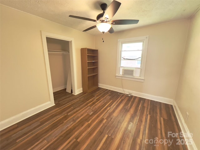413 Forest Pl NW, Lenoir, NC 28645 - unfurnished bedroom with a textured ceiling, dark wood-style flooring, a closet, and a ceiling fan