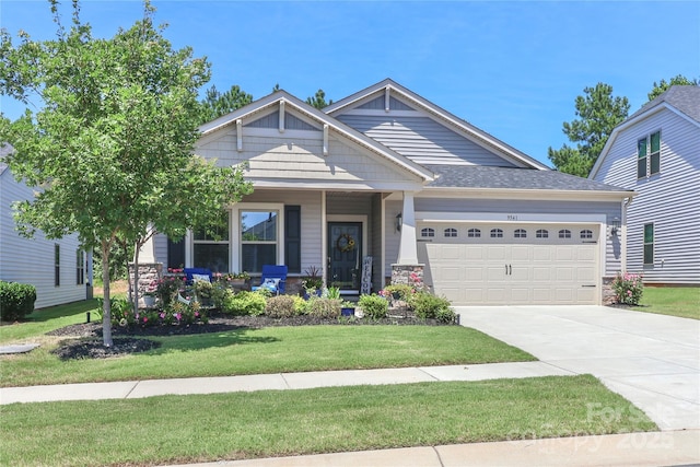 9541 Festival Way, Charlotte, NC 28215 - craftsman inspired home featuring a garage, a front lawn, driveway, and a porch