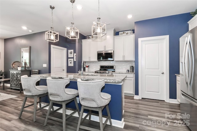 9541 Festival Way, Charlotte, NC 28215 - kitchen featuring stainless steel appliances, tasteful backsplash, dark wood-style floors, white cabinetry, and recessed lighting