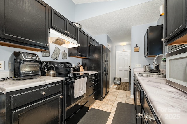 704 Willow Rd, Salisbury, NC 28147 - kitchen with black appliances, under cabinet range hood, dark cabinets, a textured ceiling, and light tile patterned floors