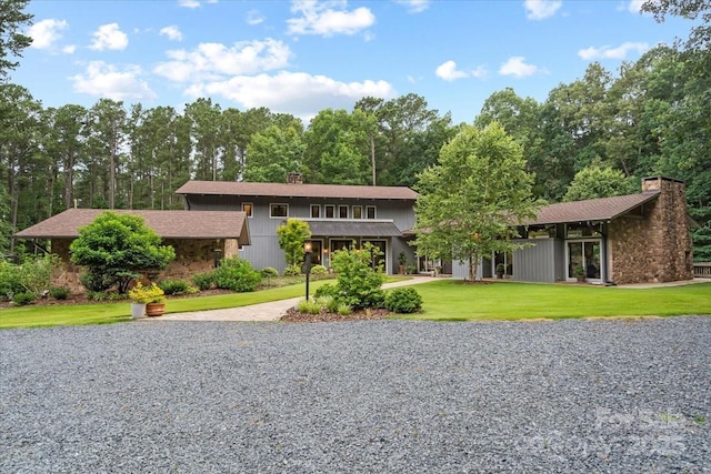 307 E Allenton St, Mount Gilead, NC 27306 - mid-century inspired home featuring a chimney, a front yard, and driveway