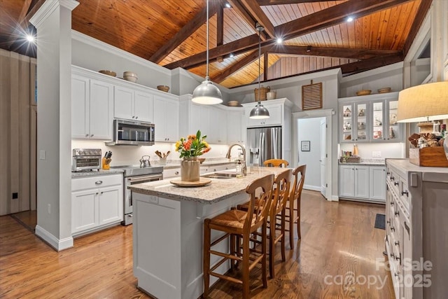 307 E Allenton St, Mount Gilead, NC 27306 - kitchen with appliances with stainless steel finishes, wood ceiling, white cabinets, a kitchen island with sink, and light wood-style flooring