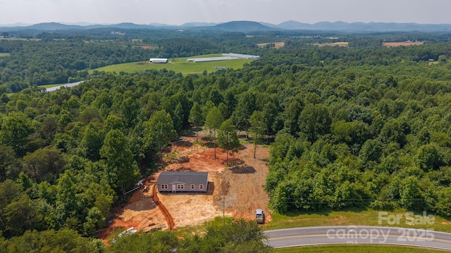 1853 Hill River Rd Unit 1, Hiddenite, NC 28636 - drone / aerial view of a heavily wooded area and a mountainous background