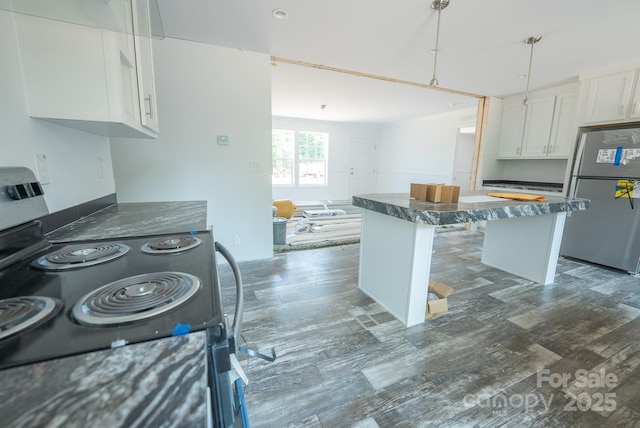 1853 Hill River Rd Unit 1, Hiddenite, NC 28636 - kitchen featuring appliances with stainless steel finishes, white cabinets, a kitchen island, wood finished floors, and open floor plan