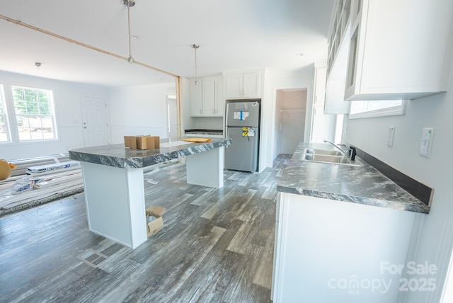 1853 Hill River Rd Unit 1, Hiddenite, NC 28636 - kitchen featuring freestanding refrigerator, white cabinets, a center island, dark countertops, and dark wood finished floors