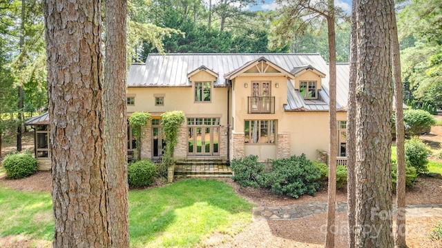 177 Yadkin Falls Rd, New London, NC 28127 - view of front of property with stucco siding, french doors, a metal roof, and stone siding