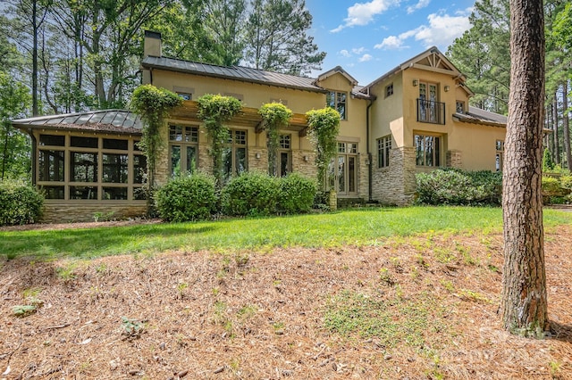 177 Yadkin Falls Rd, New London, NC 28127 - view of front facade featuring a standing seam roof, stone siding, stucco siding, and a chimney