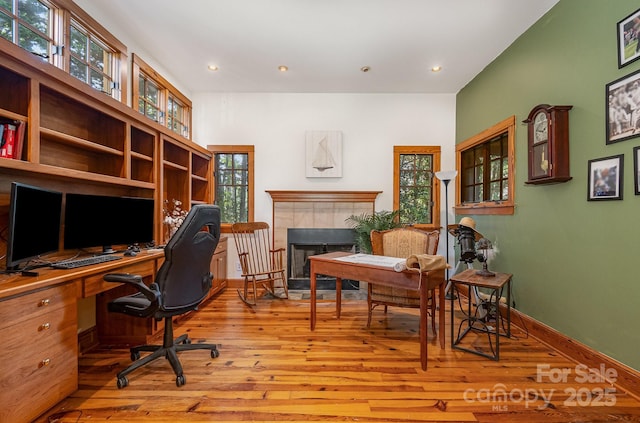 177 Yadkin Falls Rd, New London, NC 28127 - office space with hardwood / wood-style floors, a tile fireplace, and recessed lighting