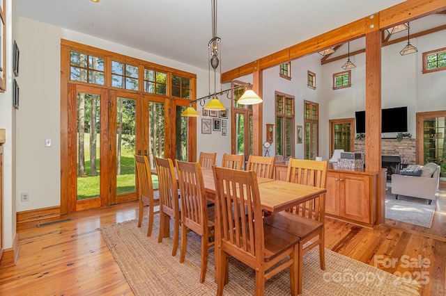 177 Yadkin Falls Rd, New London, NC 28127 - dining area with plenty of natural light, light wood finished floors, and a fireplace